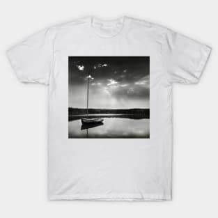 A moored yacht in calm waters at Brancaster Staithe, Norfolk, UK T-Shirt